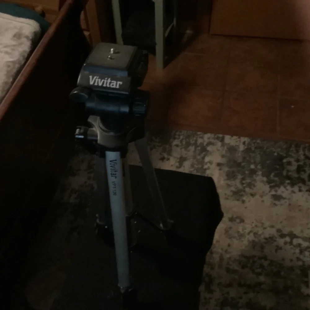 Camera tripod, adjustable.